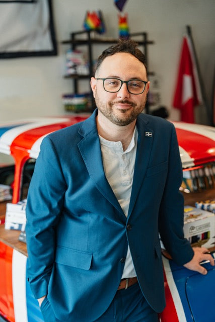 Flags For Good Founder & CEO Michael Green standing in front of a Mini Cooper