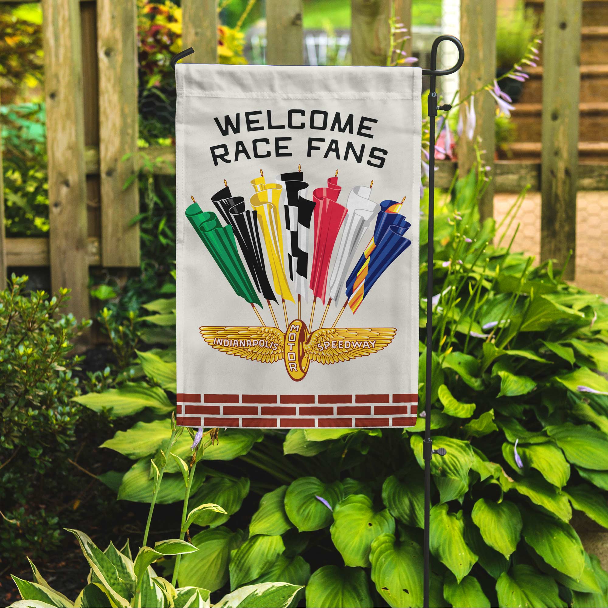 garden flag with vintage racing flags design on a garden pole in a private garden setting.