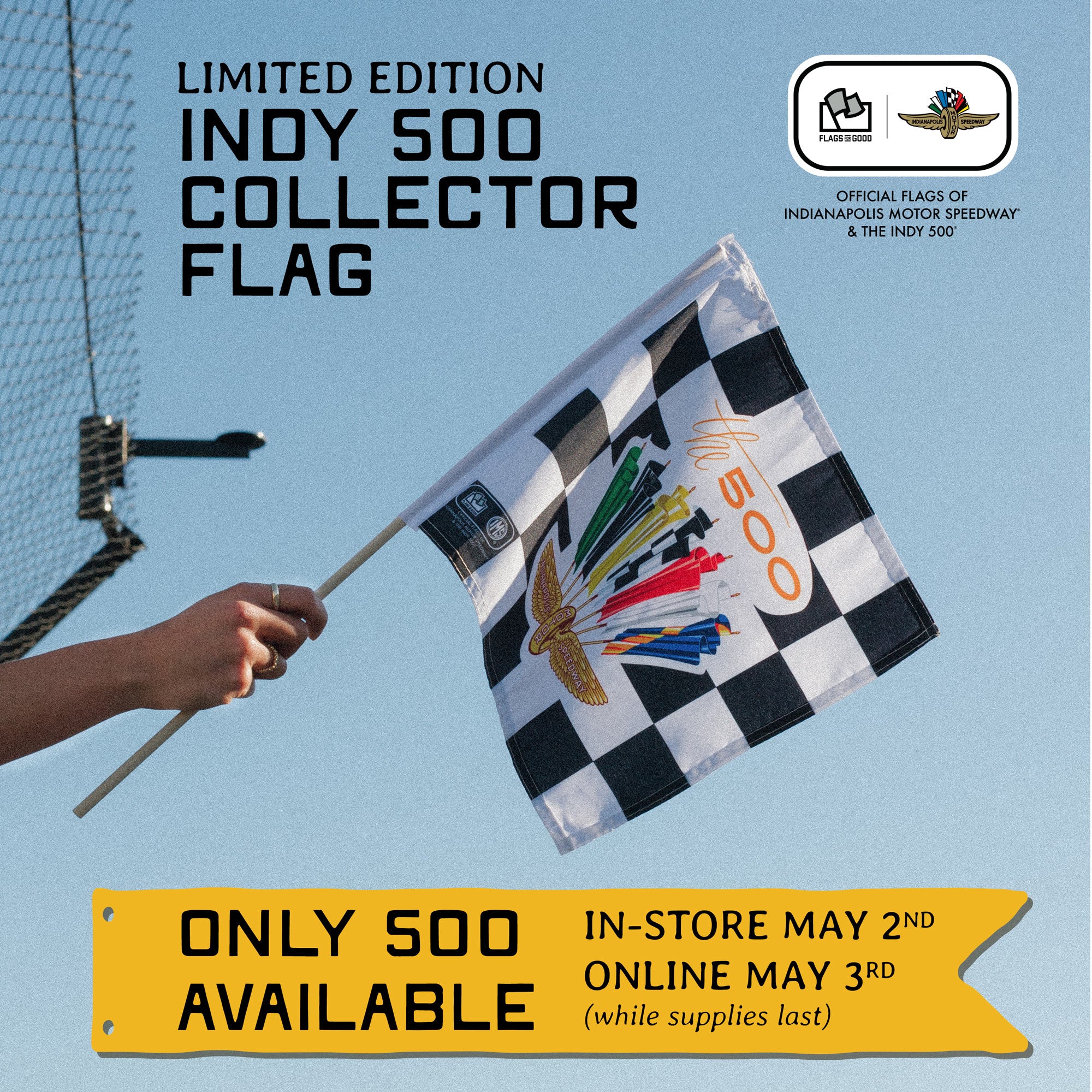 Limited edition Indy 500 collector flag held by a hand against a blue sky background.
