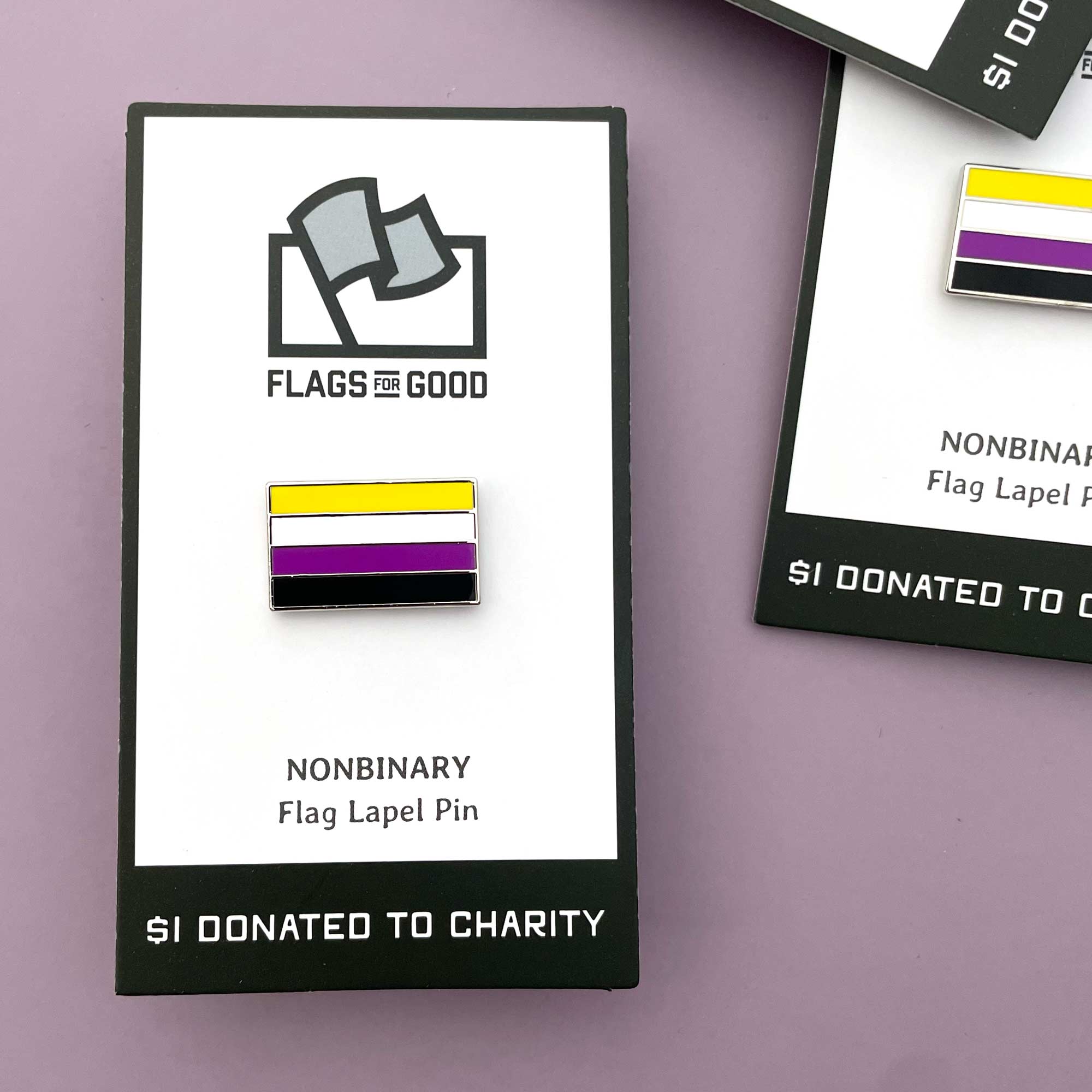 Nonbinary flag lapel pin with 'Flags for Good' packaging on a purple background