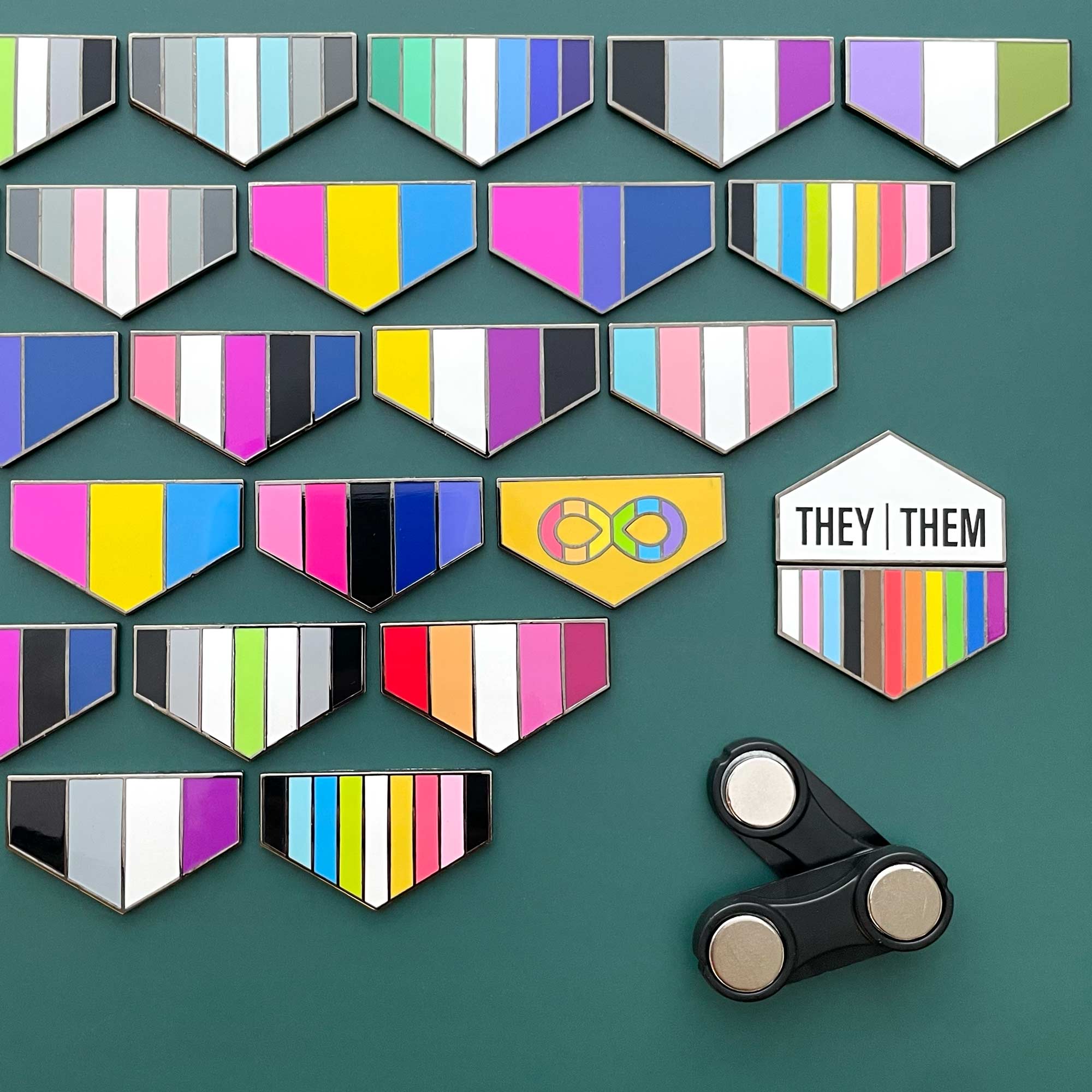 Collection of colorful geometric pins on a green background