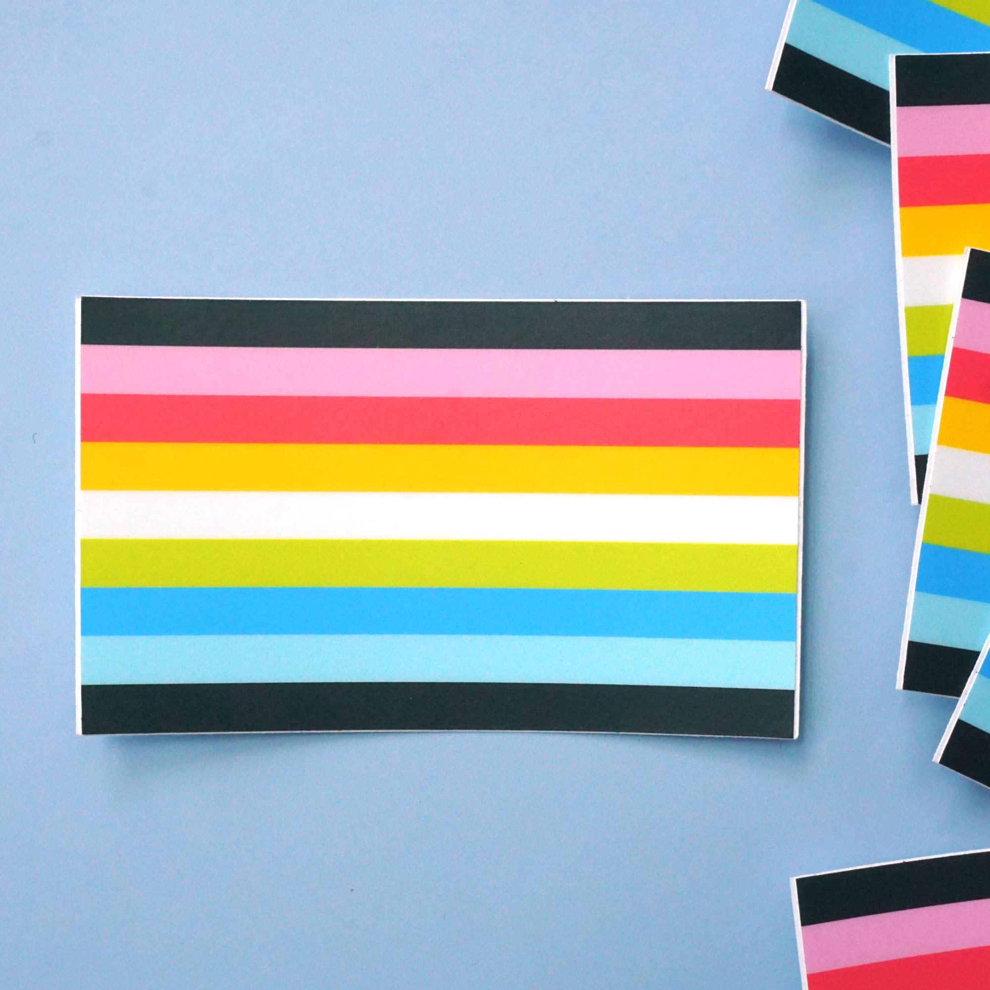 queer pride flag sticker on a light blue background