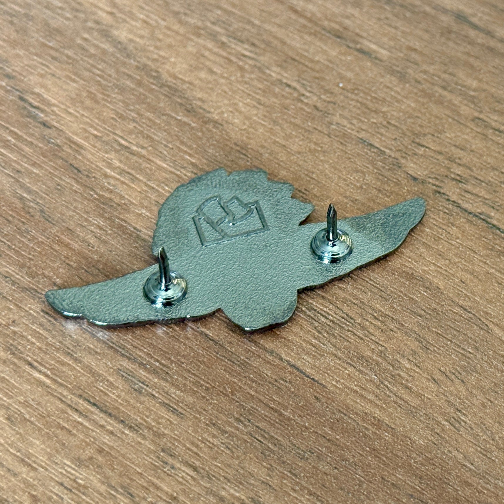 back of Indianapolis Motor Speedway pin showing the two prongs and Flags For Good logo